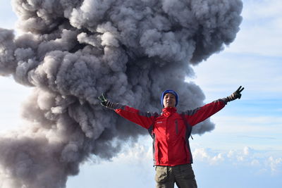 Full length of man standing on rock against sky