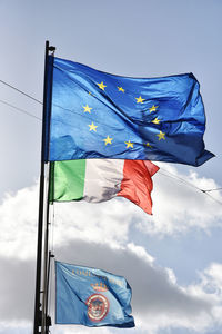 Low angle view of flag against blue sky