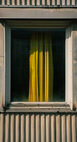 Close-up of yellow window on building