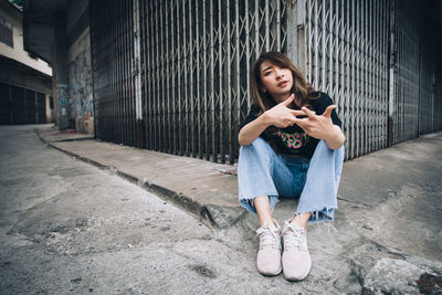 Portrait of a teenage girl sitting in city