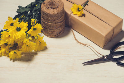 High angle view of yellow flower on table