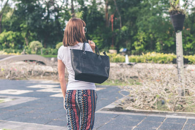 Rear view of woman standing outdoors