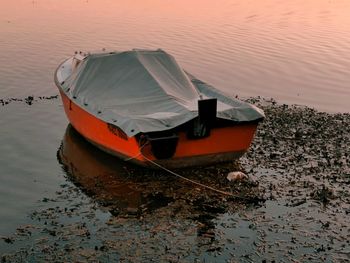 High angle view of boat moored in lake during sunset