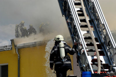 Fire department emergency response to a fire with a turntable ladder