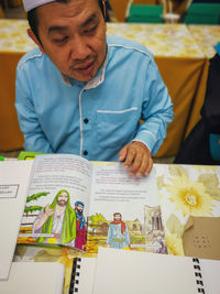 Portrait of a man sitting on table
