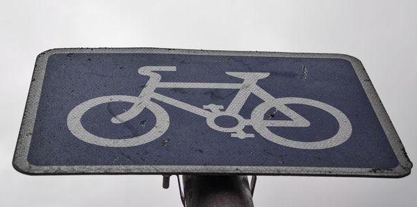 Close-up of information sign against sky