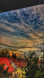 Buildings against cloudy sky