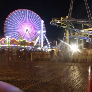 Illuminated ferris wheel at night