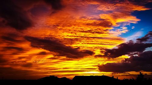 Low angle view of dramatic sky during sunset