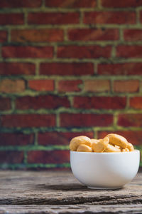 Close-up of salted cashews in bowl on table