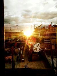 People at harbor against sky during sunset