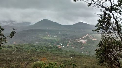 Scenic view of mountains and sea against cloudy sky
