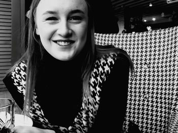 Portrait of smiling woman sitting outdoors