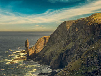 Scenic view of the old man of stoer seastack against sky at sunset, lairg, scotland.