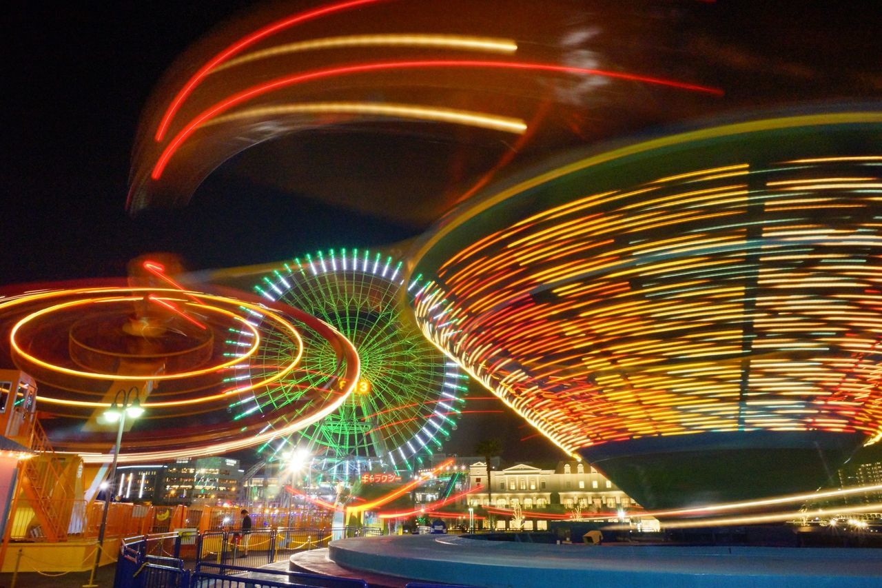 illuminated, night, long exposure, light trail, lighting equipment, glowing, multi colored, motion, arts culture and entertainment, light - natural phenomenon, pattern, blurred motion, no people, outdoors, light, light painting, speed, reflection, circle