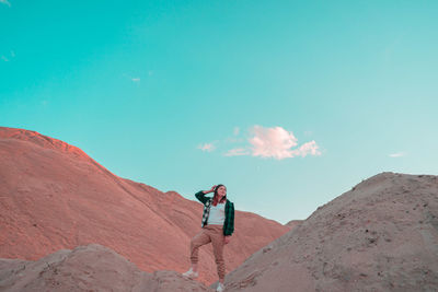 Man standing on mountain against sky