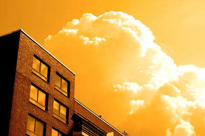 Low angle view of built structure against sunset sky