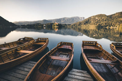 Panoramic view of boats moored in lake against sky