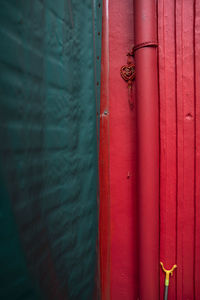 Close-up of red pipe on wall