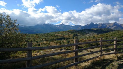 Scenic view of field and mountains against sky
