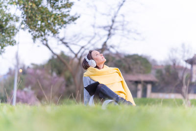 Young woman looking away on field