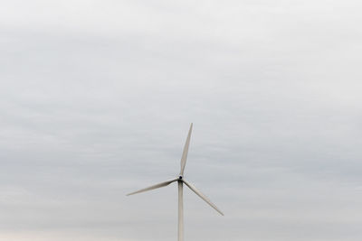 Low angle view of wind turbine against sky