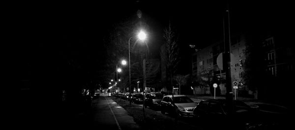 Illuminated city street at night