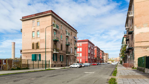 Street amidst buildings against sky in city