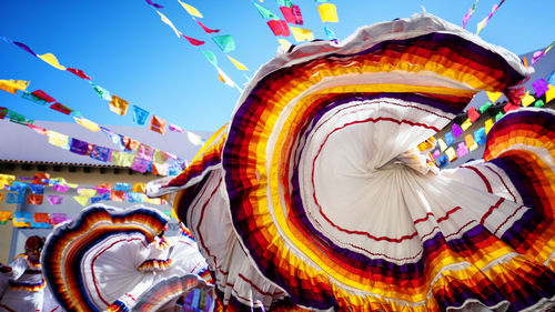 Low angle view of illuminated carousel in amusement park