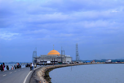 View of cathedral in city against cloudy sky