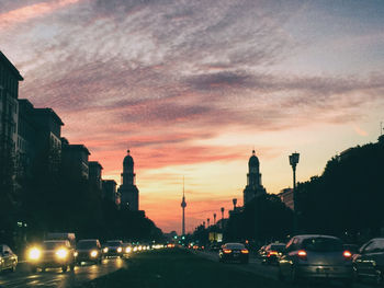 Traffic on city street during sunset