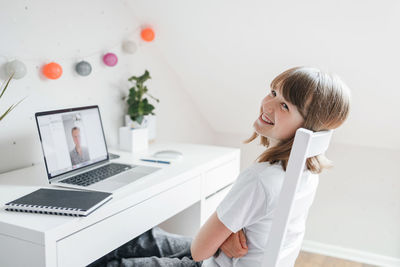 Girl teenager communicates online, makes a video call using a laptop. learning 