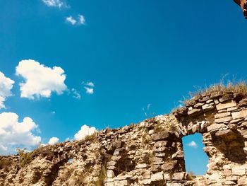 Low angle view of rock formation against sky