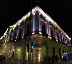 Low angle view of illuminated building at night