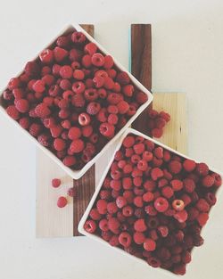 High angle view of red berries in box on table