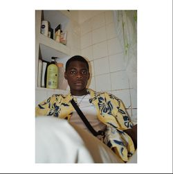 Portrait of young man standing against wall