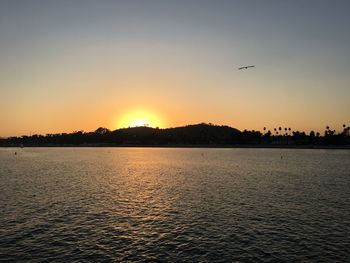 Scenic view of sea against clear sky during sunset