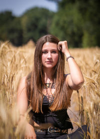 Portrait of beautiful young woman in field