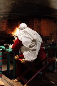 Rear view of people working in temple