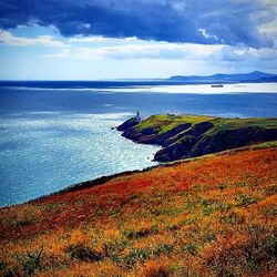 Scenic view of sea against cloudy sky