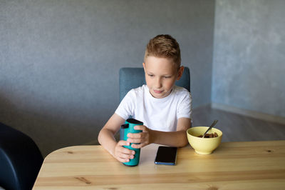 Boy playing with toy blocks on table