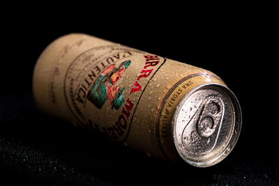 Close-up of old bottle against black background