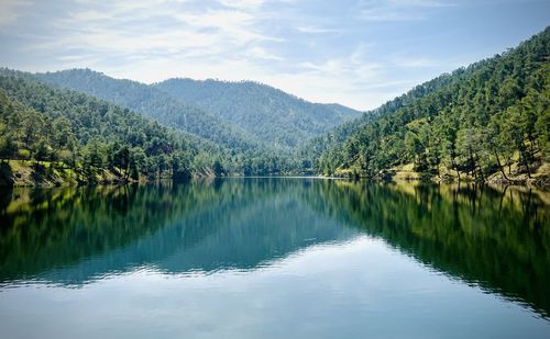 Scenic view of lake and mountains against sky