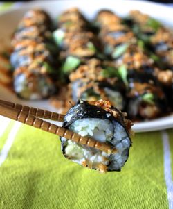 High angle view of chopsticks with sushi over table