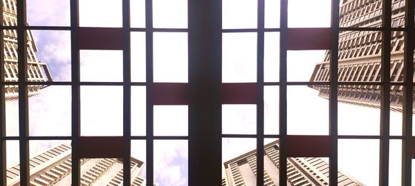 Low angle view of building seen through window