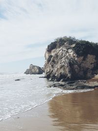 Scenic view of sea against cloudy sky