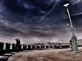 Street light against cloudy sky