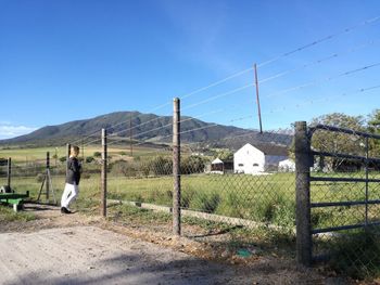 People on countryside landscape against mountain range