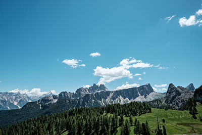 Scenic view of mountains against blue sky