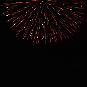 Low angle view of firework display at night